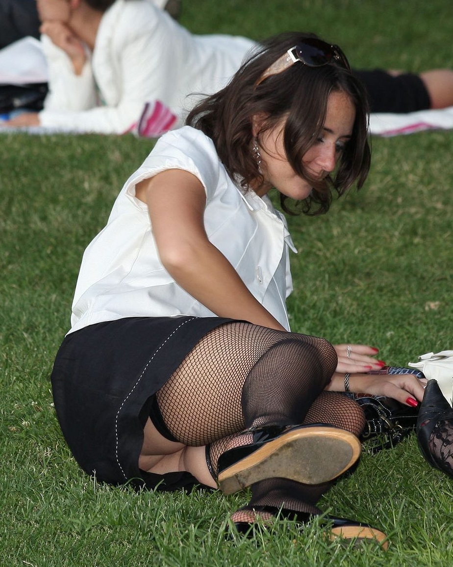 Brunette Teen Girl Upskirt wearing Black Fishnet Stockings and Black Miniskirt
